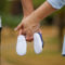 man-woman-holding-hands-baby-shoes